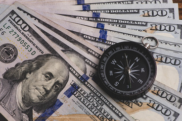 Compass and money. US banknote. Financial concept.