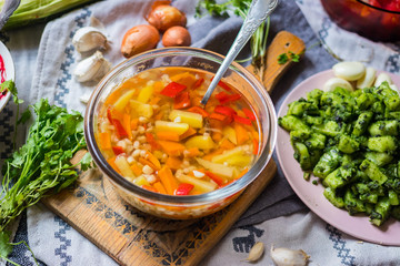 Vegetables broth soup with corn, carrot, red pepper, potato, pumpkin, onion, cabbage, spices and herbs, Vegan vegetarian healthy food lunch or dinner