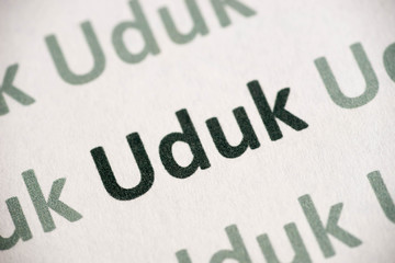 word Uduk language printed on paper macro