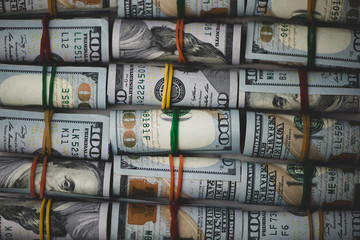 Rolled american dollars banknotes close up.