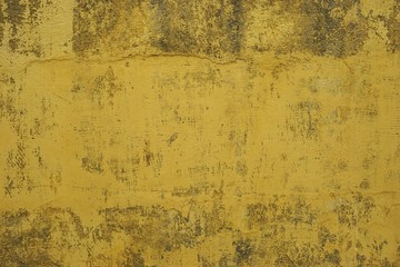 Dirty yellow wall with cross hatch scratches