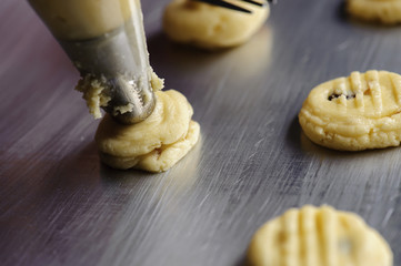 process of squeezing flour to make cookies