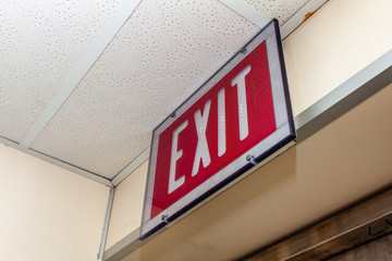 Red Fire alarm switch on the wall next to the door,Fire alarm switch.Break glass and pull down button to activate for warning and security system with hand and direction arrow,