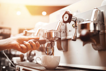 Close-up prepares espresso in coffee shop barista