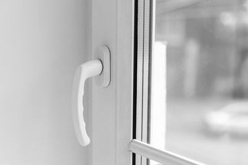 close-up handle of plastic window of white color