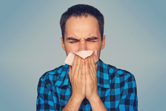 Sick man isolated has runny nose