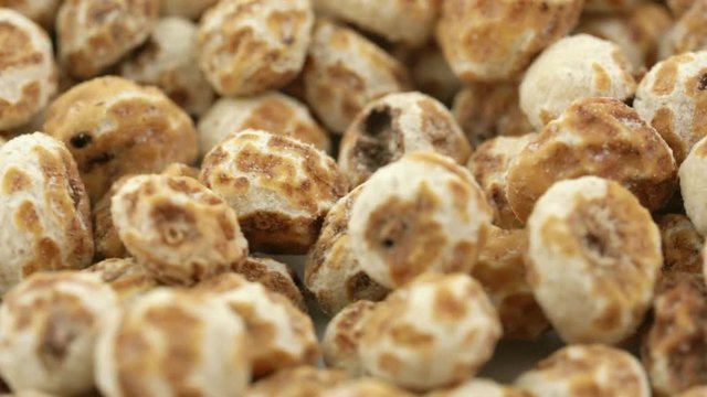 peeled tiger nuts, a rich source of resistant starch, rack focus on rotating background 