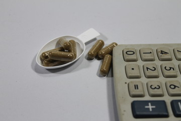 Calculator with medicine pills.