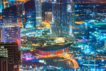 Spectacular urban skyline with colourful city illuminations. Aerial view on skyscrapers of downtown Dubai, United Arab Emirates.