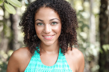 Beautiful African American Woman With Long Curly Hair, Green Eyes and Flawless Skin Wearing a...