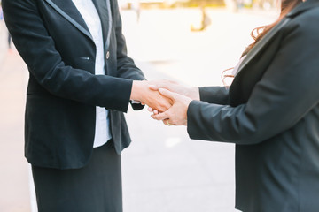 Businesswomen holding hands shake to show  the gentleness  encouragement to work with each other.