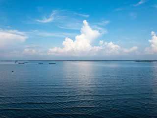 The blur cool sea background; relaxing outdoors vacation with heavenly mind view at a resort deck touching sunshine, sky surf summer clouds.