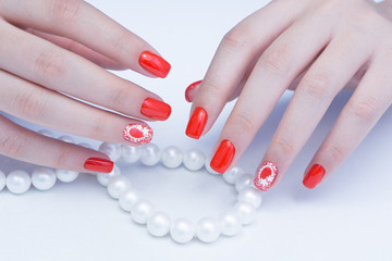 Attractive manicure on women's hands. Natural finger nails with stylish nail art.