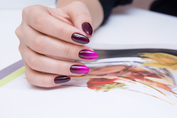 Attractive manicure on women's hands. Natural finger nails with stylish nail art.