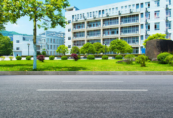 University building under a clear sky, outside is a clean asphalt road