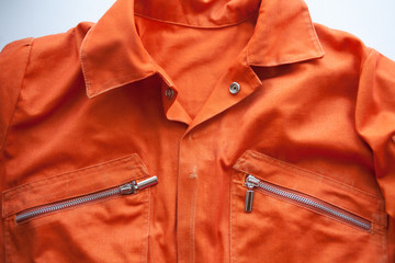 An orange jumpsuit of a prisoner. Prison clothes, prisoner overalls - obrazy, fototapety, plakaty