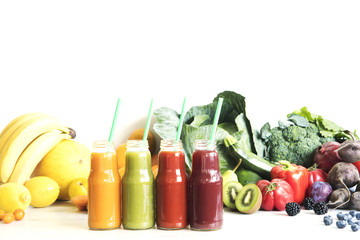 Composition of healthy colorful vegetable juices and smoothies with chia and flax seeds in glass bottles, set vegetables and fruits on the white background, copy space