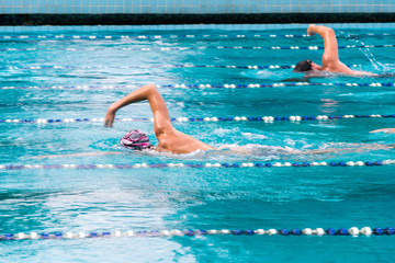 two swimmers are swimming in the swimming pool