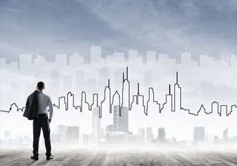 Motivation and inspiration concept with modern cityscape and businessman observing it