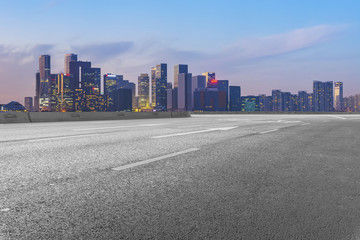 Urban road asphalt pavement and skyline of Hangzhou architectural landscape