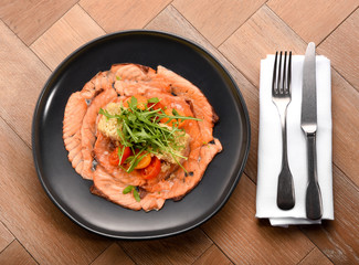 Fresh gourmet smoked salmon slices with salad