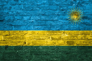 Flag of Rwanda over an old brick wall background, surface