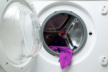 Image of open washing machine with violet cloth
