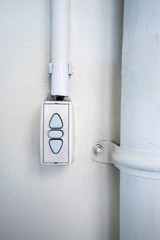 Controller switch installed on white wall background