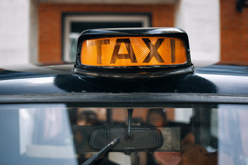 Old taxi lamp on the roof of vintage car