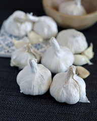 group of garlic heads on black background