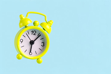 Alarm clock on a blue background. Early awakening, good morning