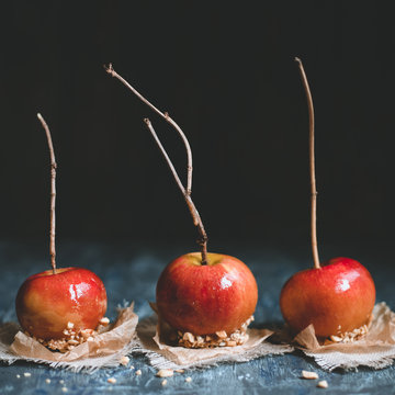 Old fashioned caramel apples with brunch sticks and nuts. Square crop