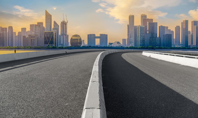 Fototapeta premium Urban road asphalt pavement and skyline of Hangzhou architectural landscape