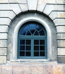 Detail of old building. Classy window in a greenish color.