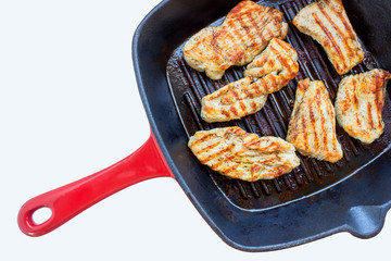 Roasted chicken breast in grill pan, top view.