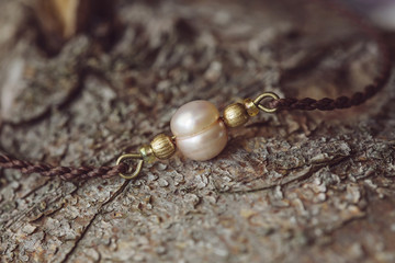 Pearl bracelet on wooden background