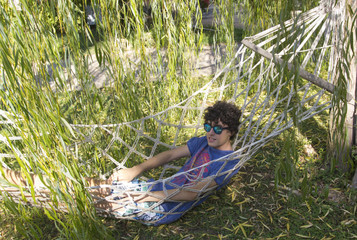 Happy teen is resting on the hammock © dogmer