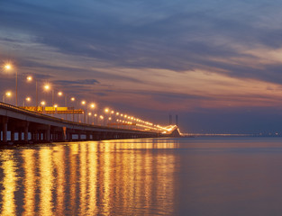 Fototapeta na wymiar The Penang bridge against the background of colourful dawn