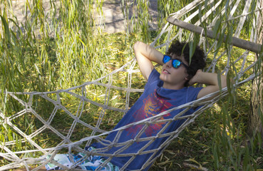 Happy teen is resting on the hammock © dogmer