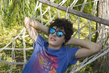 Happy teen is resting on the hammock © dogmer