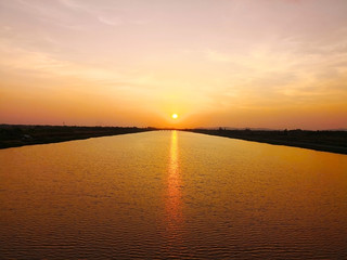 The travelling and life concept. The sun is falling in the dusk. The golden light of the sun...