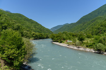 Fototapeta na wymiar Wide mountain river in Abkhazia, Georgia
