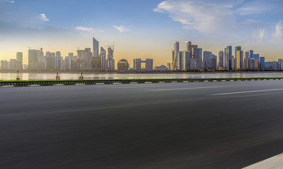 Obraz premium Urban road asphalt pavement and skyline of Hangzhou architectural landscape
