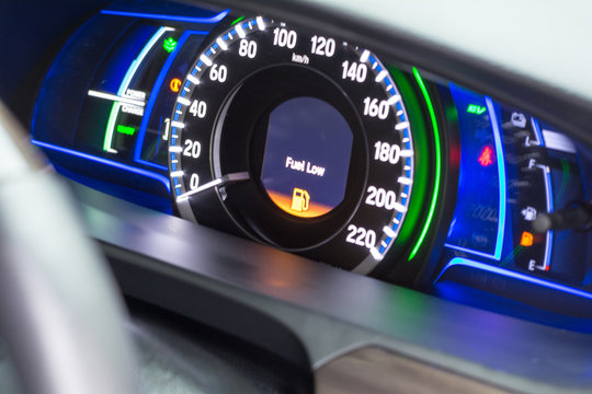 Close up empty Petrol, gasoline gauge dash board in car with digital warning sign of run out of fuel turn on on black background. Low level of fuel show on speedometer dashboard.Odometer Day - Powered by Adobe