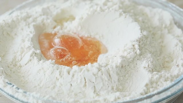 Falling egg into flour