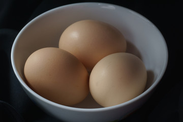 Brown eggs in a white cup ready to eat