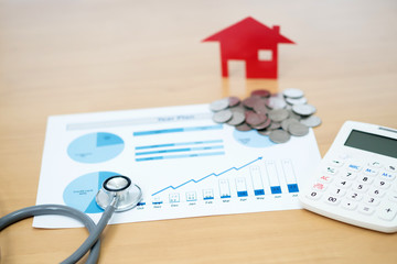 Concept stethoscope Home graph and coin