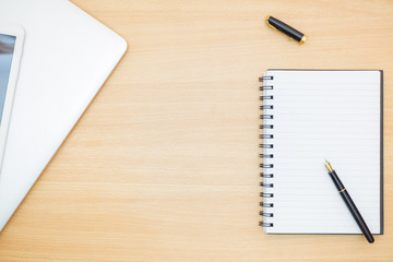 Flat lay photography. Empty notebook and a pen on a wooden table. Write memo office idea concept.