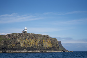 Fototapeta na wymiar A small lighthouse on the island of Canna, the westernmost of the Small Isles archipelago, in the Scottish Inner Hebrides.