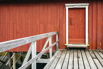 Traditional norwegian red house called rorbu. The entrance door.